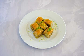 Turkish Dessert Sobiyet, havuc dilimi, midye baklava, mussels baklava and classic baklava with Pistachio . Cikolatali cevizli, fistikli soguk Baklava, top view.