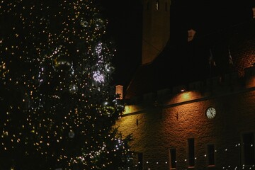 Christmas tree at christmas market at town hall of europe city decorated with lights at night