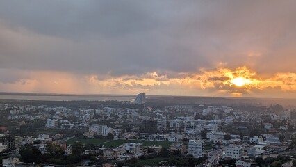 The photo shows an aerial view of the city of Limassol, Cyprus, during sunset.