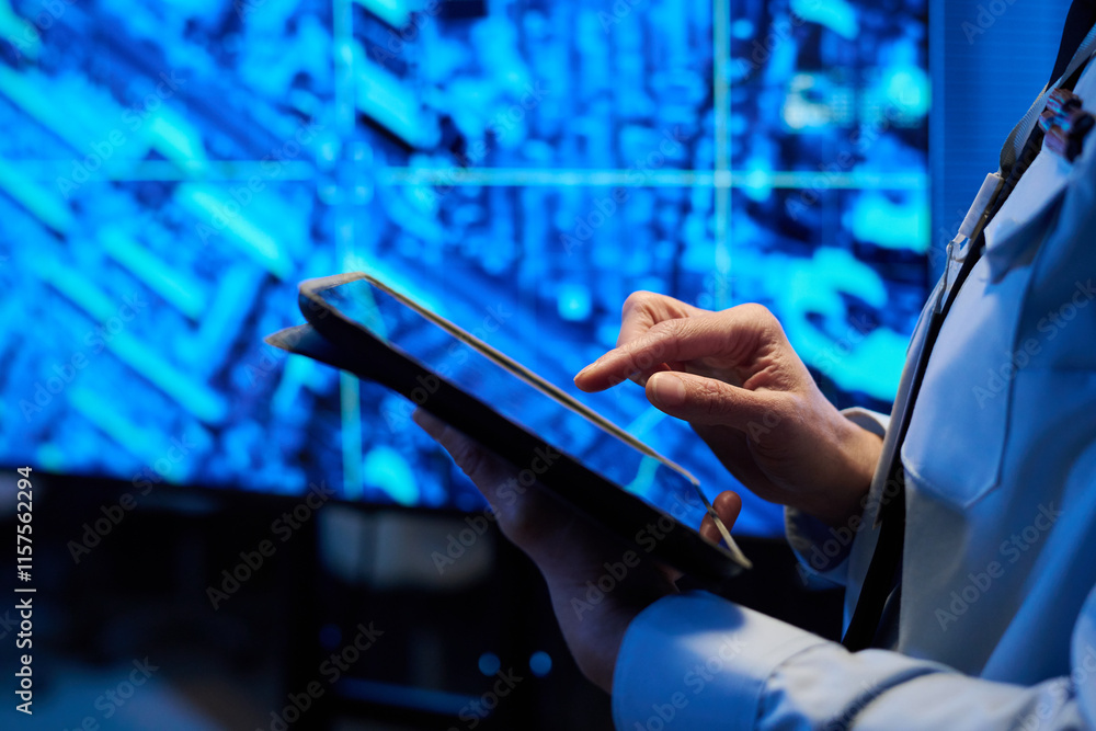 Fototapete hand of female officer in uniform pointing at screen of tablet while standing in front of camera aga