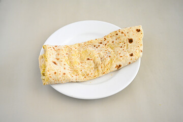 Freshly baked appetizing Turkish tortillas - Gozleme with spinach, cheese  on a wooden board. Space for text. Shallow depth of  field. Handmade traditional  Patatesli, Ispanakli, peynirli gozleme.