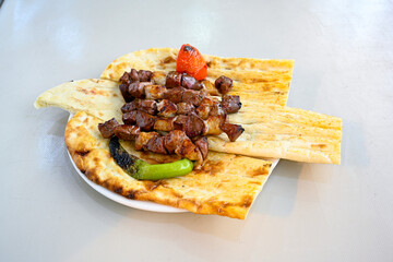 Famous Urfa meat liver, ciger wrapped by lavash with roasted chili pepper, onion and sauce in Sanliurfa, Turkey. Kuzu et ciger sis. Izgara dana bonfile, cop sis, kuzu pirzola. Karisik kebap, beyti keb