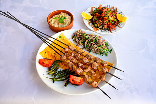 Famous Urfa meat liver, ciger wrapped by lavash with roasted chili pepper, onion and sauce in Sanliurfa, Turkey. Kuzu et ciger sis. Izgara dana bonfile, cop sis, kuzu pirzola. Karisik kebap, beyti keb