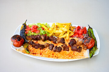 Famous Urfa meat liver, ciger wrapped by lavash with roasted chili pepper, onion and sauce in Sanliurfa, Turkey. Kuzu et ciger sis. Izgara dana bonfile, cop sis, kuzu pirzola. Karisik kebap, beyti keb
