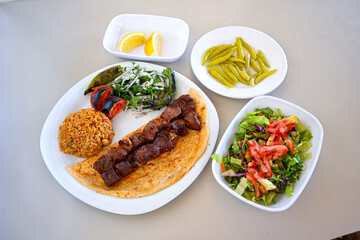 Famous Urfa meat liver, ciger wrapped by lavash with roasted chili pepper, onion and sauce in...