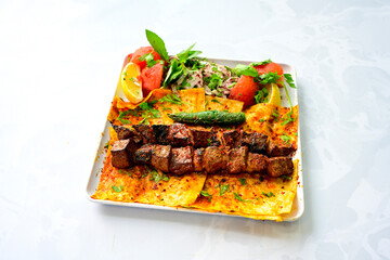 Famous Urfa meat liver, ciger wrapped by lavash with roasted chili pepper, onion and sauce in Sanliurfa, Turkey. Kuzu et ciger sis. Izgara dana bonfile, cop sis, kuzu pirzola. Karisik kebap, beyti keb