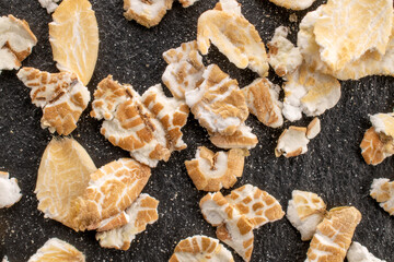 Fototapeta premium Oatmeal rolled with homemade kitchen utensils, close-up, top view.