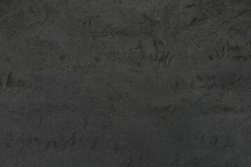 Rough gray wall texture with old abstract patterns and chaotic scratches. Matte discolored aged surface. Minimalist dark background 