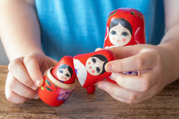 Nesting doll (Matryoshka) in the hands of a child.