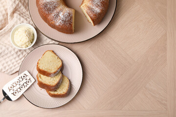Pieces of freshly baked sponge cake, server and ice cream on wooden table, top view. Space for text