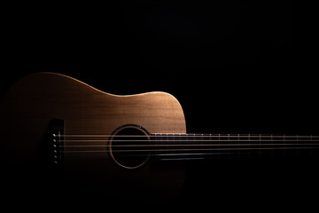 Acoustic guitar on black background