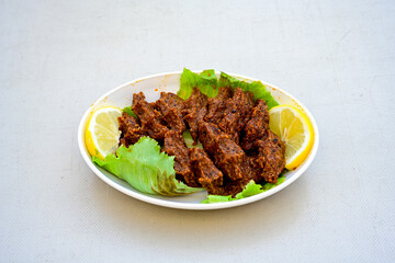 Cig kofte (raw meatball) with lettuce, tomato, pickle and lemon, hot Chee kofta. Turkish local raw food concept.Table scene of assorted take out or delivery foods. Doritoslu duble cig kofte durum.