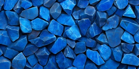 A collection of irregularly shaped blue stones, varying in size and texture, creating a visually striking pattern. Concept Blue Stones Collection, Irregular Shapes, Textural Variety