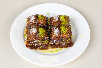 Turkish Dessert Sobiyet, havuc dilimi, midye baklava, mussels baklava and classic baklava with Pistachio . Cikolatali cevizli, fistikli soguk Baklava, top view.