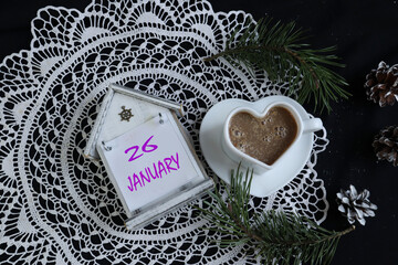 Calendar for January 26: white napkin on a black background, cup, name of the month January,...