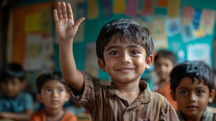 Fototapeta premium A boy proudly raising his hand during a lesson, with colorful posters and blurred classmates visible behind