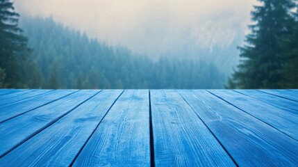 Blue Wooden Table in Front of Misty Forest Landscape with Pine Trees