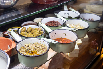 Artisanal delicatessen in Rome with fresh tomatoes, fruits, olives, and Italian delicacies