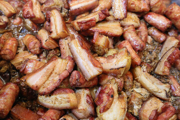 Grilled traditional sausage and different tipe of meat prepared on grill at a Christmas market where various traditional dishes are served.