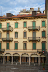 Fototapeta premium Bright yellow European mid century residential building with green window frames and columns in Lugano, Switzerland