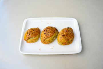 Turkish pastry product , tasty pogaca. Simit, gevrek. Turkish Pastries; peynirli, patatesli, kasarli pogaca, borek, acma, ay coregi at patisserie showcase.