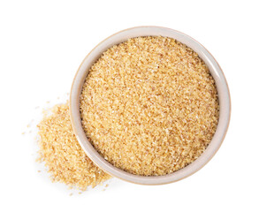 Raw wheat groats in bowl isolated on white, top view
