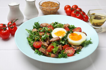 Delicious fresh tuna salad and ingredients on white tiled table, closeup