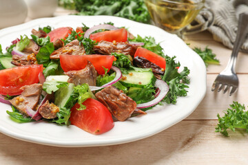 Delicious fresh tuna salad served on wooden table, closeup