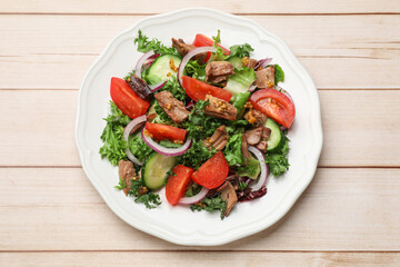 Delicious fresh tuna salad on wooden table, top view