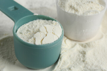Pile of protein powder and scoops, closeup