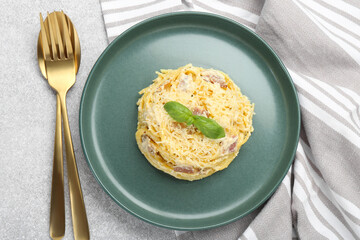 Delicious pasta Carbonara served on gray table, flat lay