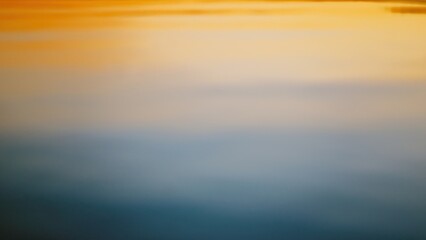 Fototapeta premium Soft water background in sunset colors - from blue to orange