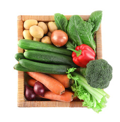 Different ripe vegetables in wicker box isolated on white, top view