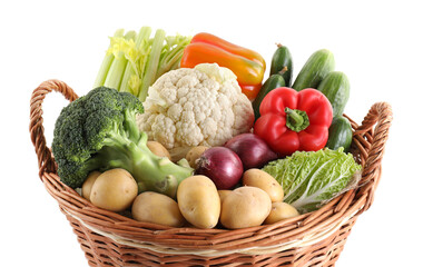 Different ripe vegetables in basket isolated on white