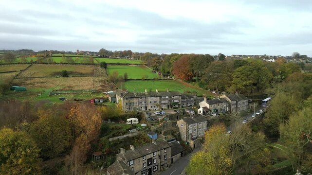 Pull-back aerial footage of Jackson Bridge village at sunset in Holmfirth, West Yorkshire, England
