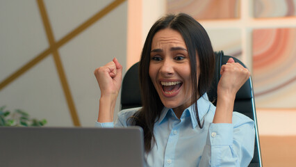 Happy excited amazed Caucasian woman hispanic businesswoman cheerful girl female employer office manager looking at laptop screen celebrate amazing news achieve good offer online victory win surprise