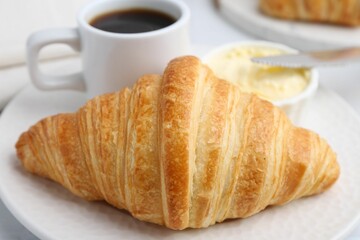 Tasty fresh croissant served on white table, closeup