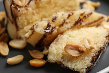 Delicious sweet semolina halva with peanuts on plate, closeup