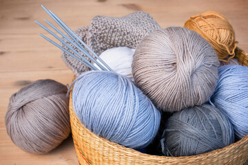 basket of yarn and knitting needles