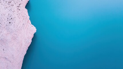 Serene Aerial View of Turquoise Water Meeting Pink Rock Formation