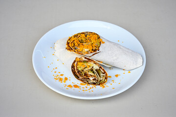 Cig kofte (raw meatball) with lettuce, tomato, pickle and lemon, hot Chee kofta. Turkish local raw food concept.Table scene of assorted take out or delivery foods. Doritoslu duble cig kofte durum.