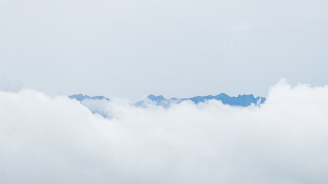 Misty mountain tops emerging above clouds in San Ramon