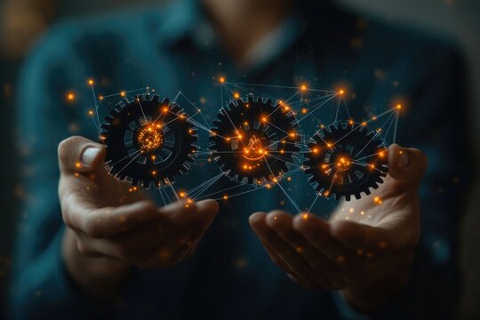 A person holding two gears in their hands