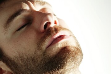 Obraz premium A close-up shot of a man's face with his eyes closed, ideal for use in photoshooting or as a symbol in various contexts
