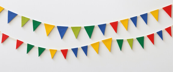 Obraz premium Bright and colorful triangular party bunting with bold primary colors, slightly textured finish, and layered arrangement against a vibrant white background, perfect for festive celebrations.
