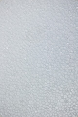 Texture of polystyrene foam packaging or white insulation close by, synthetic foam. Concept: Construction, building material, building site.