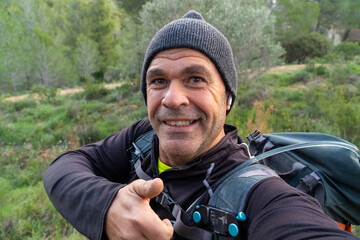 A mountaineer taking a selfie on a winter morning in the mountains.