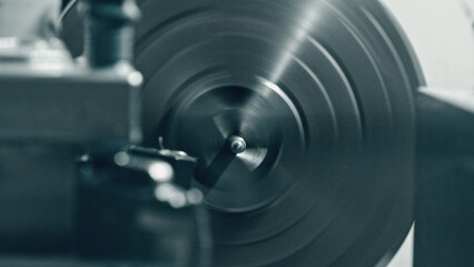 Fototapeta premium Close up view of a metal lathe rotating at high speed during a machining process, highlighting the intricate precision and dynamic motion inherent in industrial metalworking