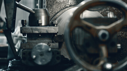 Fototapeta premium Close up view of a metal lathe expertly shaping a metal workpiece, highlighting the intricate precision and complexity involved in industrial metalworking processes