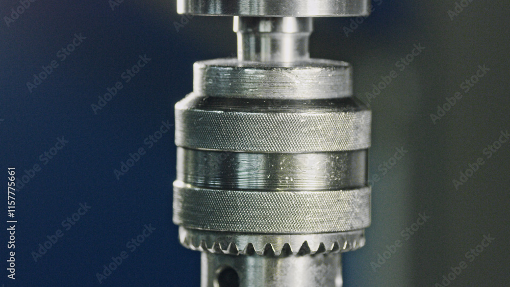 Poster close up of a drill chuck rotating, showcasing its intricate mechanism and highlighting the precisio